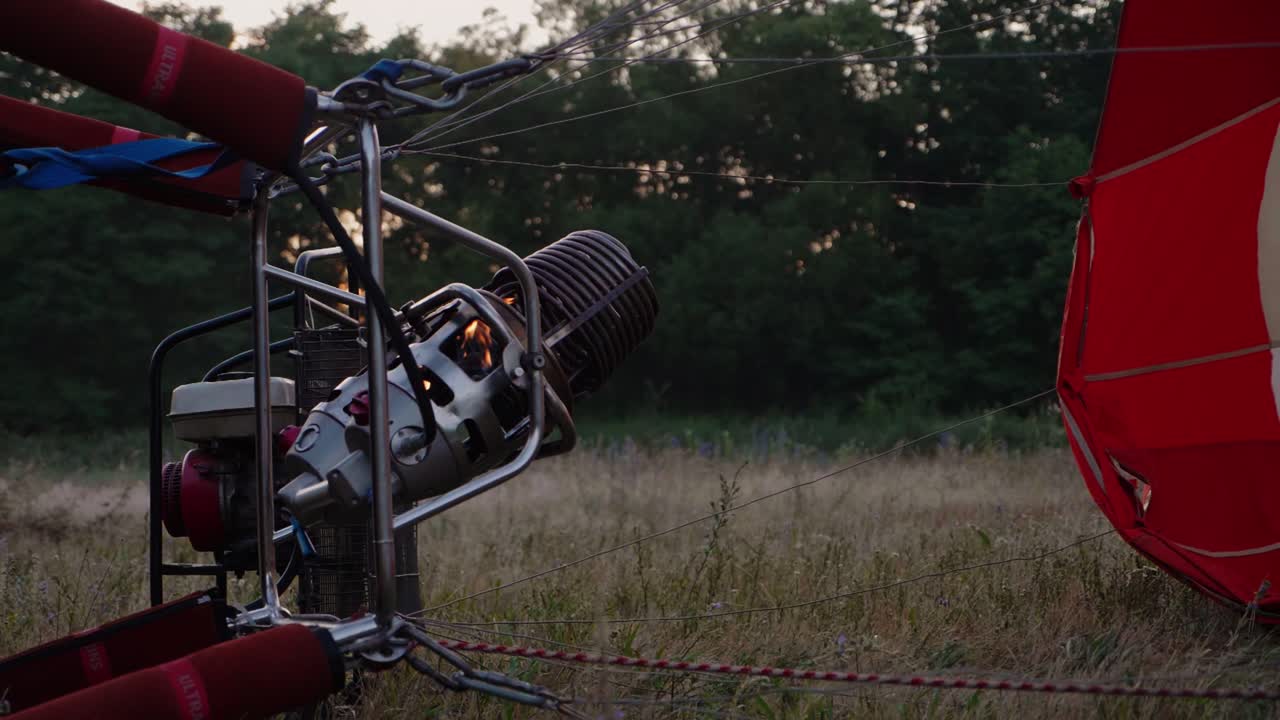 close up shot of the burner mechanism of a balloon before take of at early morning in french countryside
