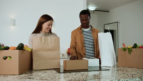 couple unpacking groceries