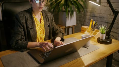 woman working late at night on laptop in office