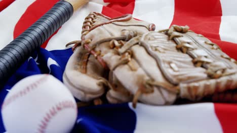 Baseball,-baseball-bat-and--baseball-gloves-on-an-American-flag