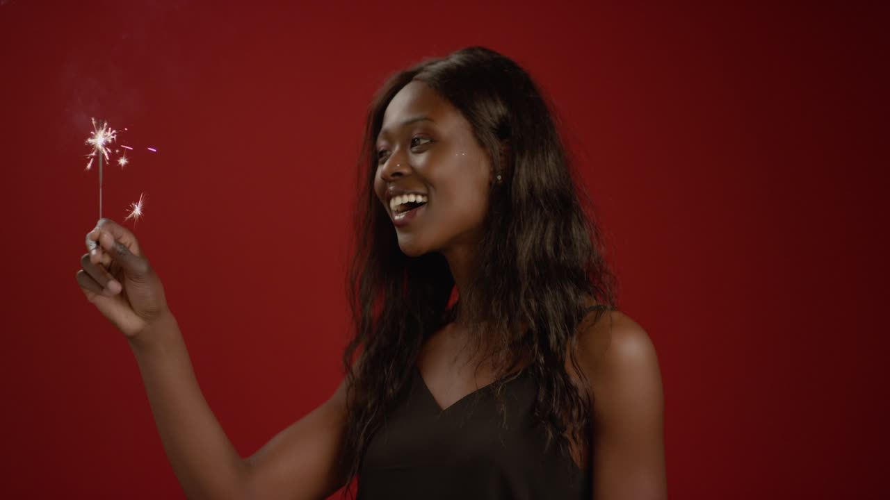 Young Woman Dances with a Sparkler