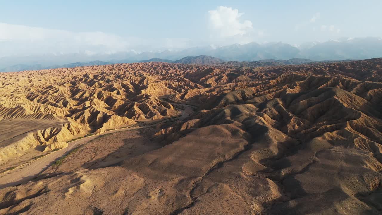 Aerial view of Ak Sai Canyons The Valley of Forgotten Rivers in Kyrgyzstan southern Issyl Kol lake at sunset
