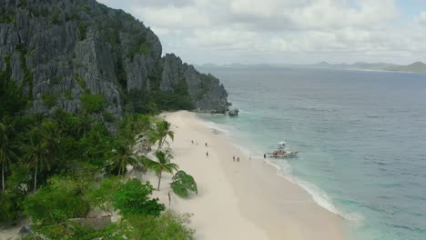 Antenne-über-Malajon-Island-Beach-Mit-Touristen,-Die-Mit-Dem-Boot-Anreisen