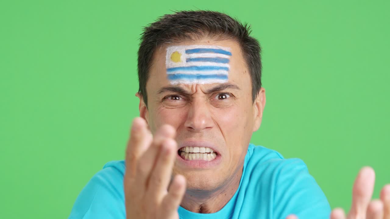 Man with uruguayan national flag upset with a referee