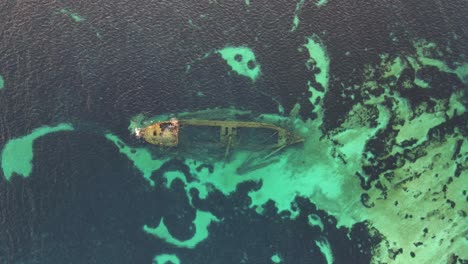 aerial view of submerged shipwreck in turquoise waters