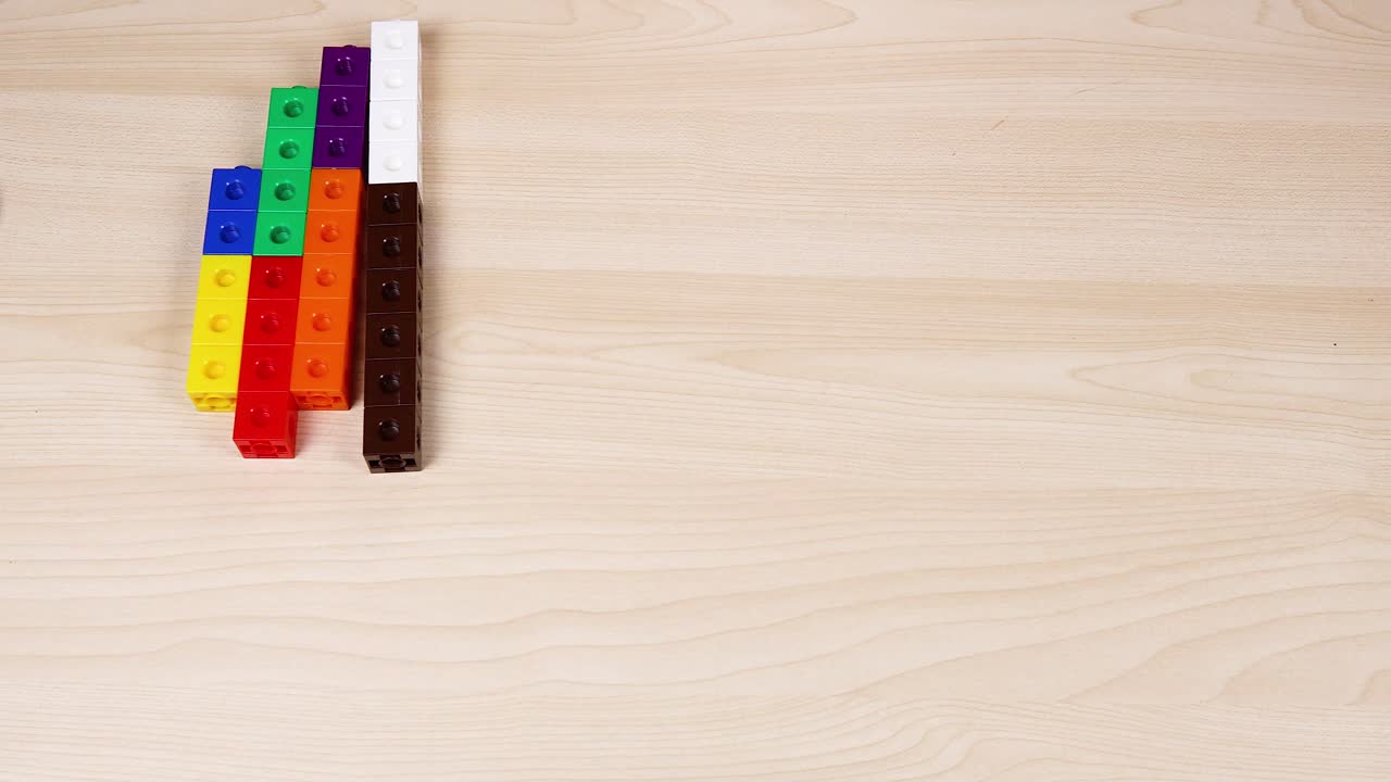 손 은 테이블 에 다채로운 큐브 를 정리 하고 있다