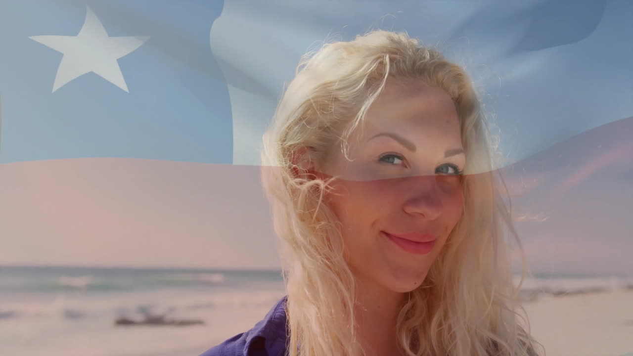 Holding transparent flag, woman smiling at beach with animation overlay in sky