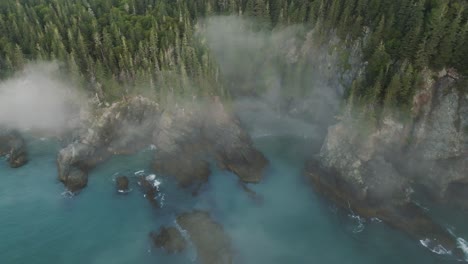 breathtaking aerial view looks down on misty cliffs and blue waves on maine coast