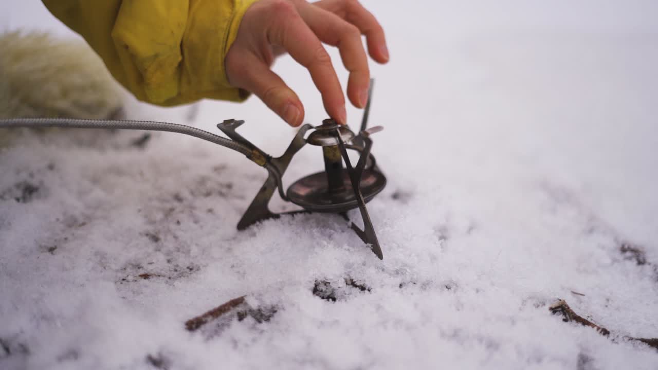 Setting up a Portable Gas Stove in the Snow