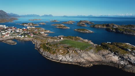 famous football pitch in henningsvær. island village with ocean and cliff background. lofoten, norway