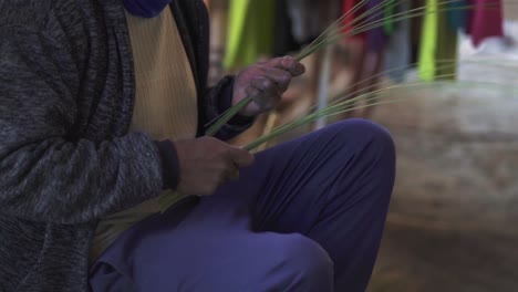 close-up shot of a man's hands in tucumán, argentina, making crafts with skill, showing traditional crafts and cultural heritage