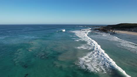aerial orbiting over crashing waves at berry bay