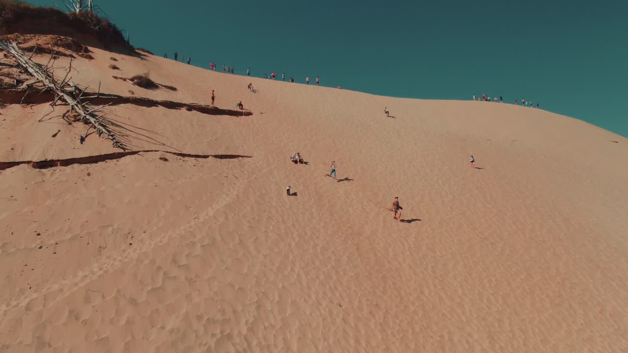 4k Aerial Sand dune with people running down