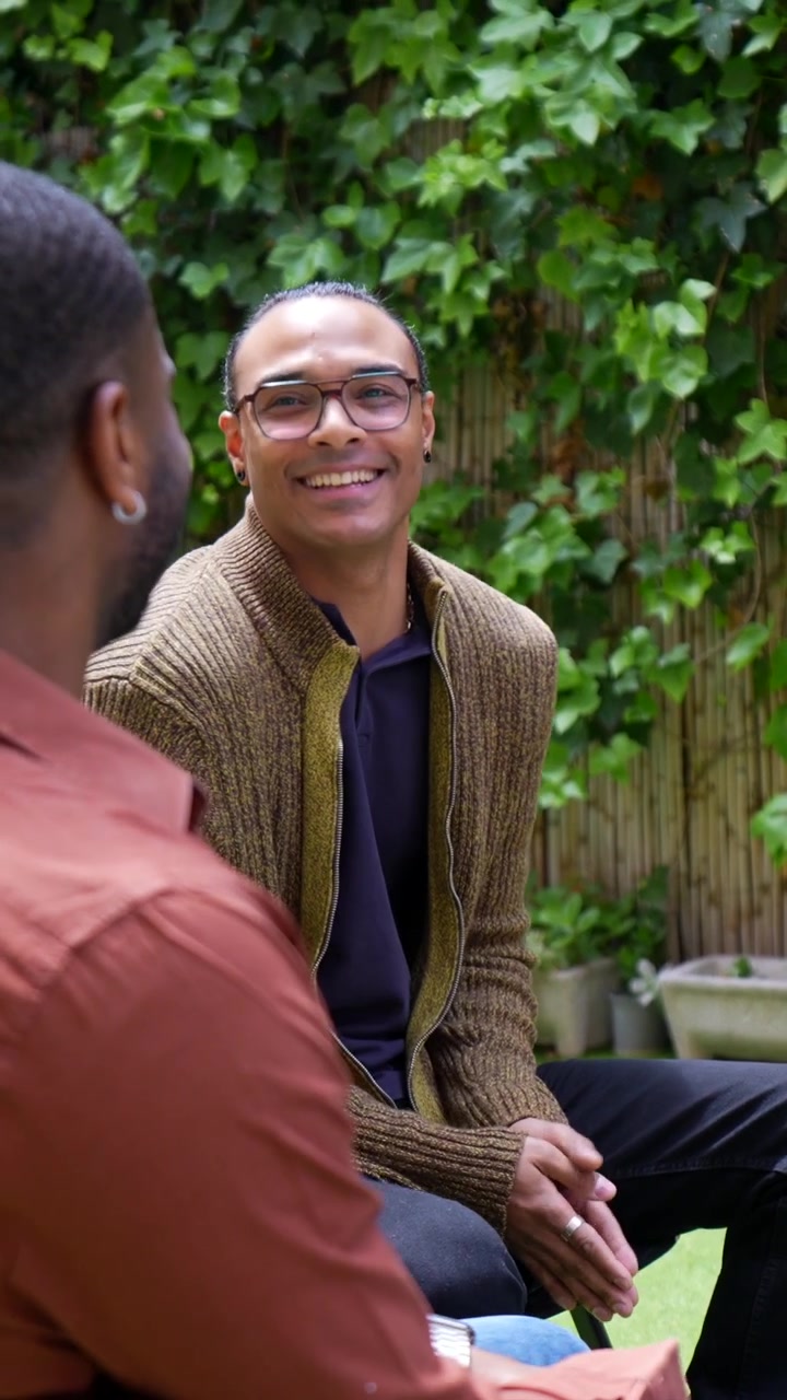 Two Men Having a Friendly Conversation in a Garden