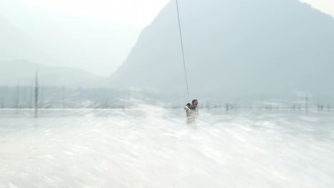 Front-view-of-caucasian-young-man-doing-tricks-on-wakeboard-in-the-city-river-4k