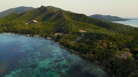 panoramic-aerial-view-of-Karimunjawa-National-Park,-an-Indonesian-island-with-turquoise-sea-water-and-green-forest-at-sunset-time---Central-Java,-Indonesia