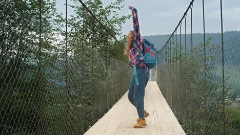 excited hitchhiker walking mountains nature. happy girl enjoy freedom outdoors.