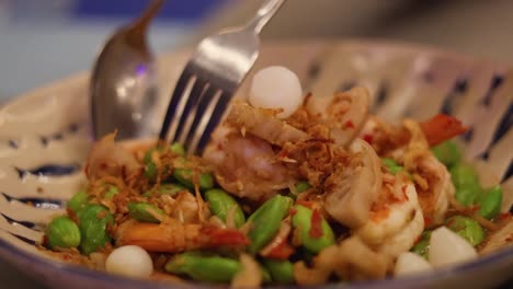 a vibrant dish with prawns and lotus root