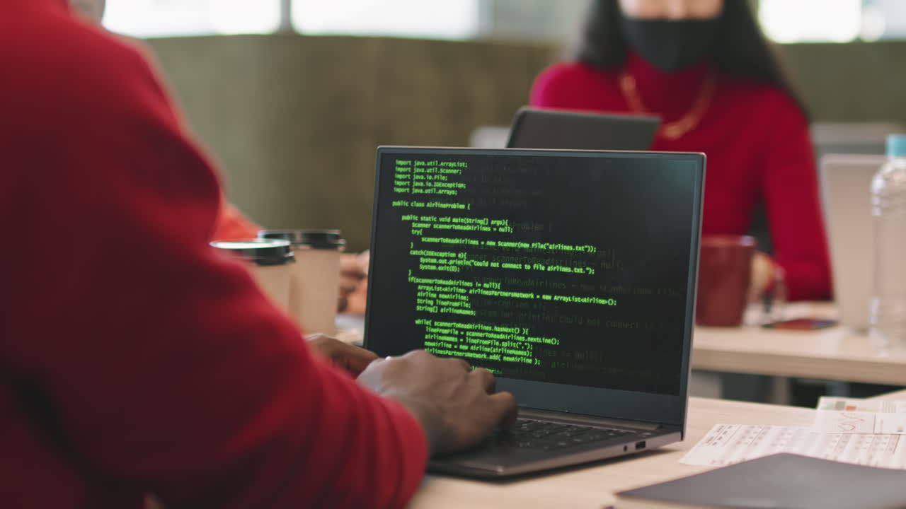 Programmer Coding on Laptop