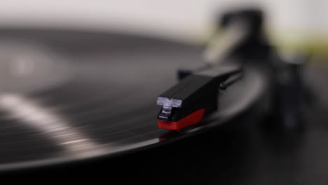 A-close-up-shot-of-a-needle-being-placed-on-a-spinning-record-vinyl