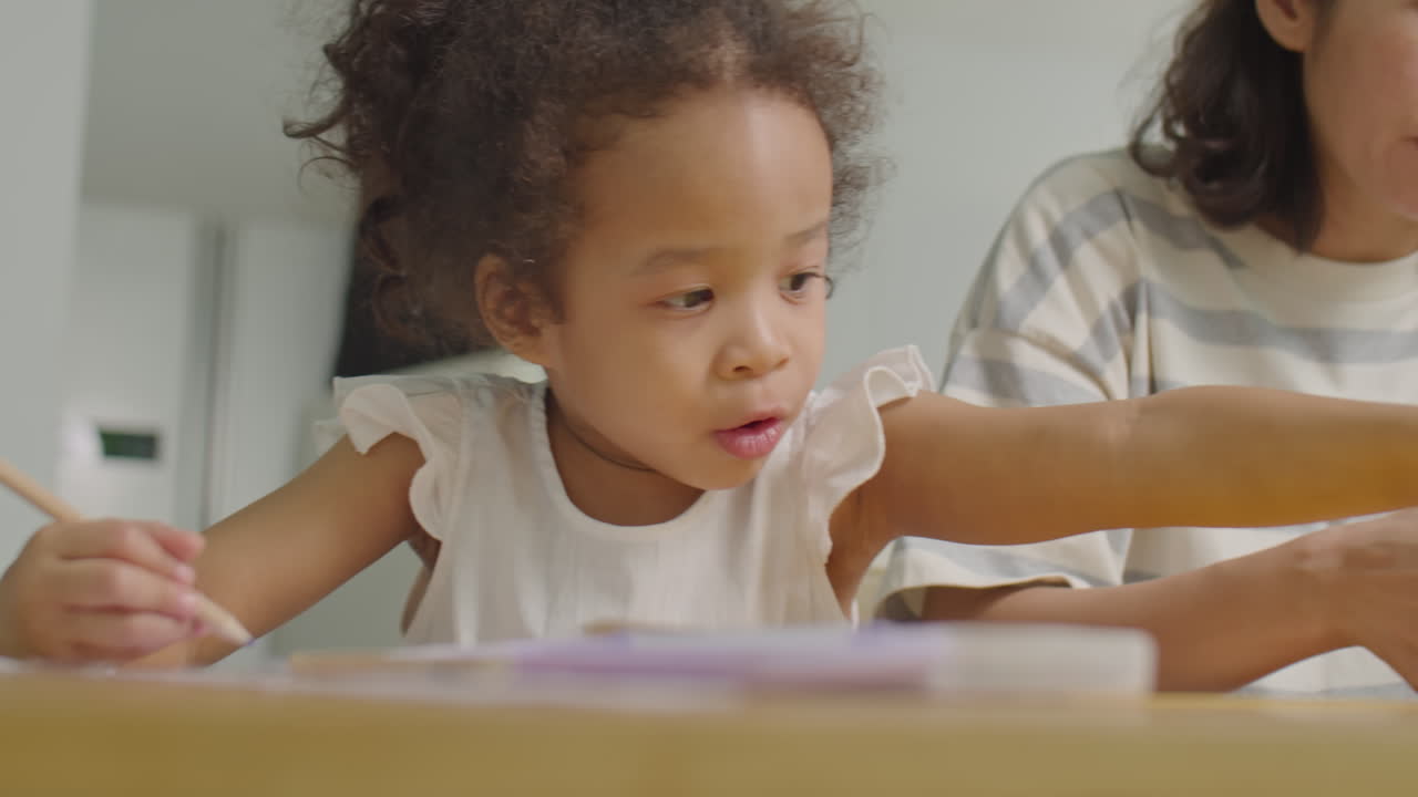 Asian Girl and Mother Drawing and Doing Paper Crafts