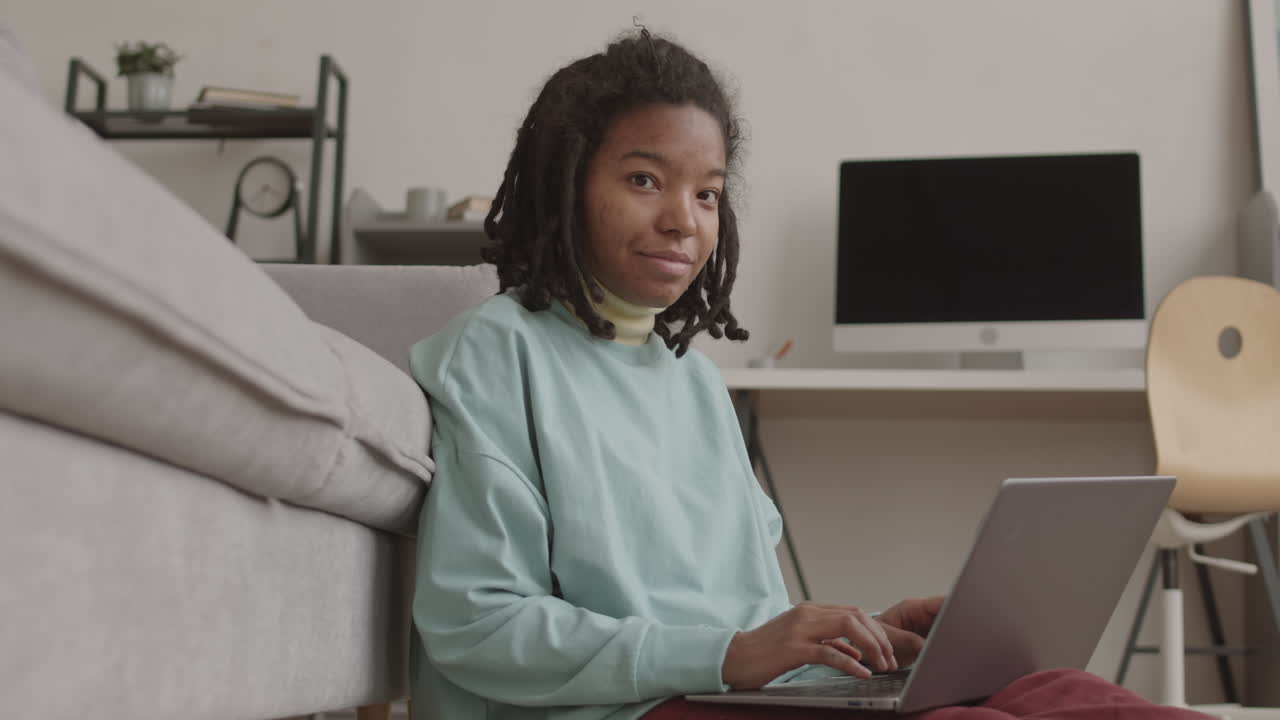 Portrait of African Teenage Girl Using Laptop at Home