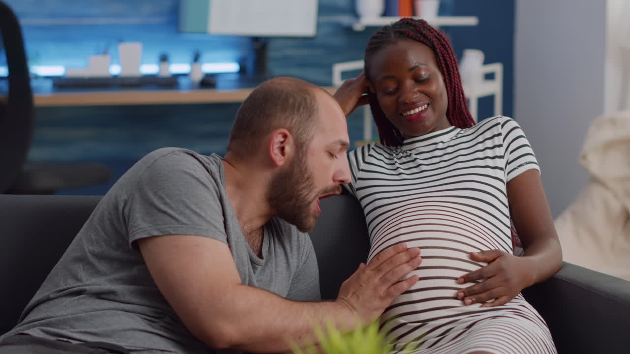Married interracial couple expecting child bonding at home