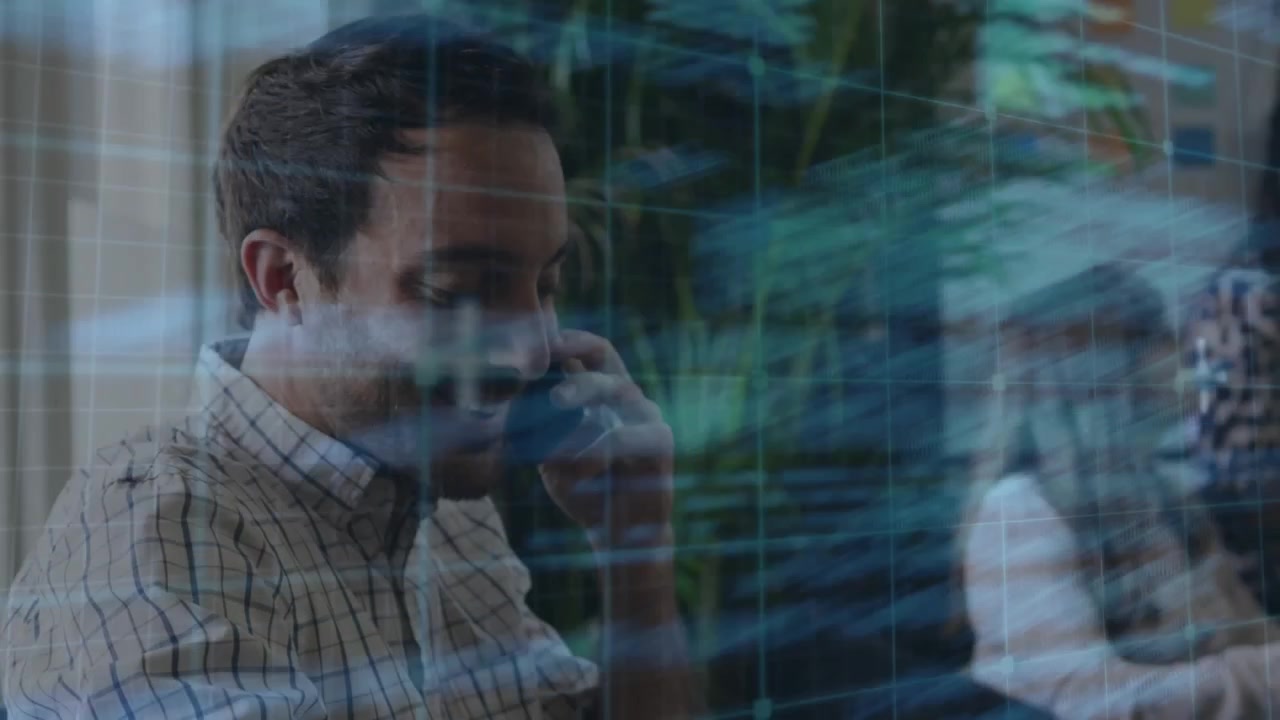 Developer lifting handset scanning translucent code overlay confirming routines and jotting notes