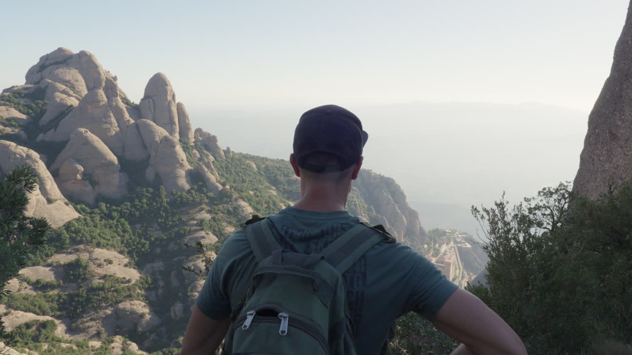 Hiker's Panoramic View: Gazing Over Vast Mountain Tops on an Early Summer Day