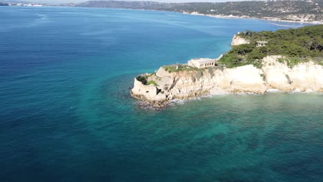 drone flying forward over castle on a small island