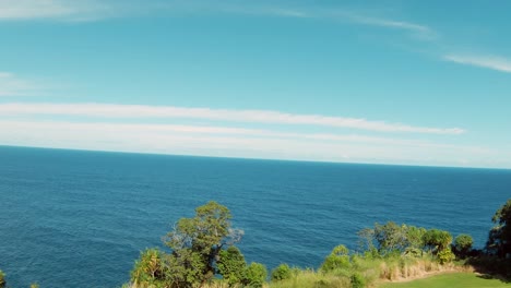 A-tourist-golfer-playing-golf-on-the-Big-Island-in-Hawaii,-USA-surrounded-by-lush-green-foliage-and-greenery-and-leading-to-the-Pacific-Ocean-4K-UHD