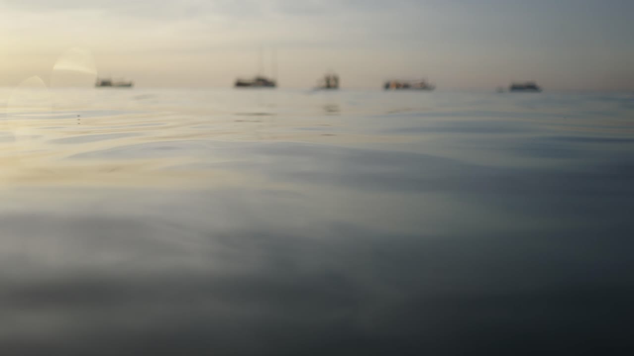 Blurred Boats on the Horizon at Sea