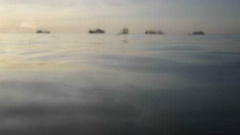 blurred boats on the horizon at sea