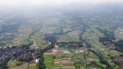 majestic rural landscape with towns and rice fields in indonesia, aerial view