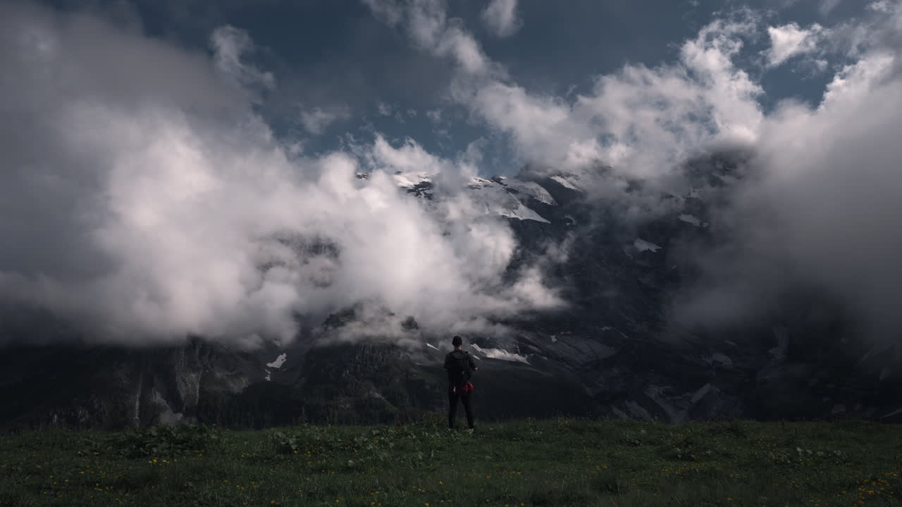 Hiker Contemplating the Majestic Swiss Alps