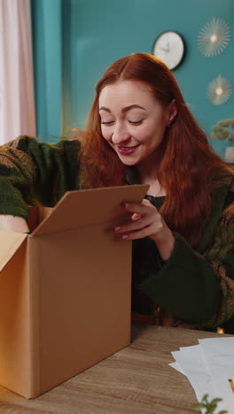 Happy-woman-shopper-unpacking-cardboard-box-delivery-parcel-online-shopping-purchase-at-home-office