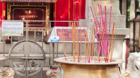 incense sticks burning in a temple setting