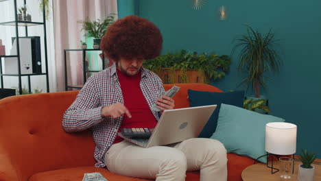 rich happy man counting money cash and use calculator, calculate domestic income earnings at home