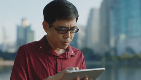 man using tablet in city