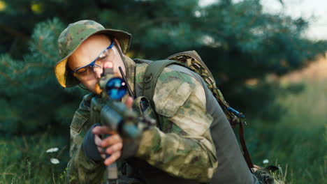 a solider aims his rifle 3