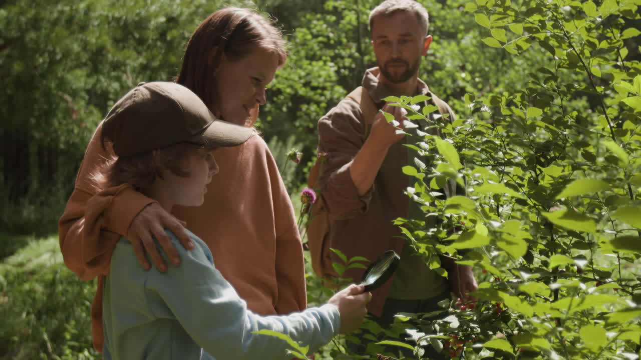 Family Exploring Nature with Magnifying Glass