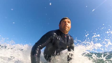 professional surfer turning and riding a big blue ocean wave with power