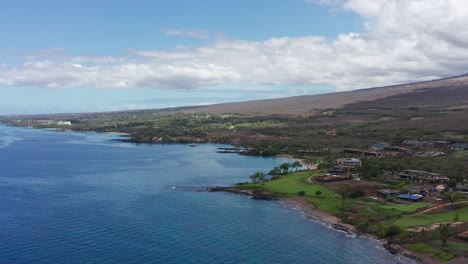 descending aerial panning shot of scenic maluaka beach, also known as turtle town, in south maui, hawai'i