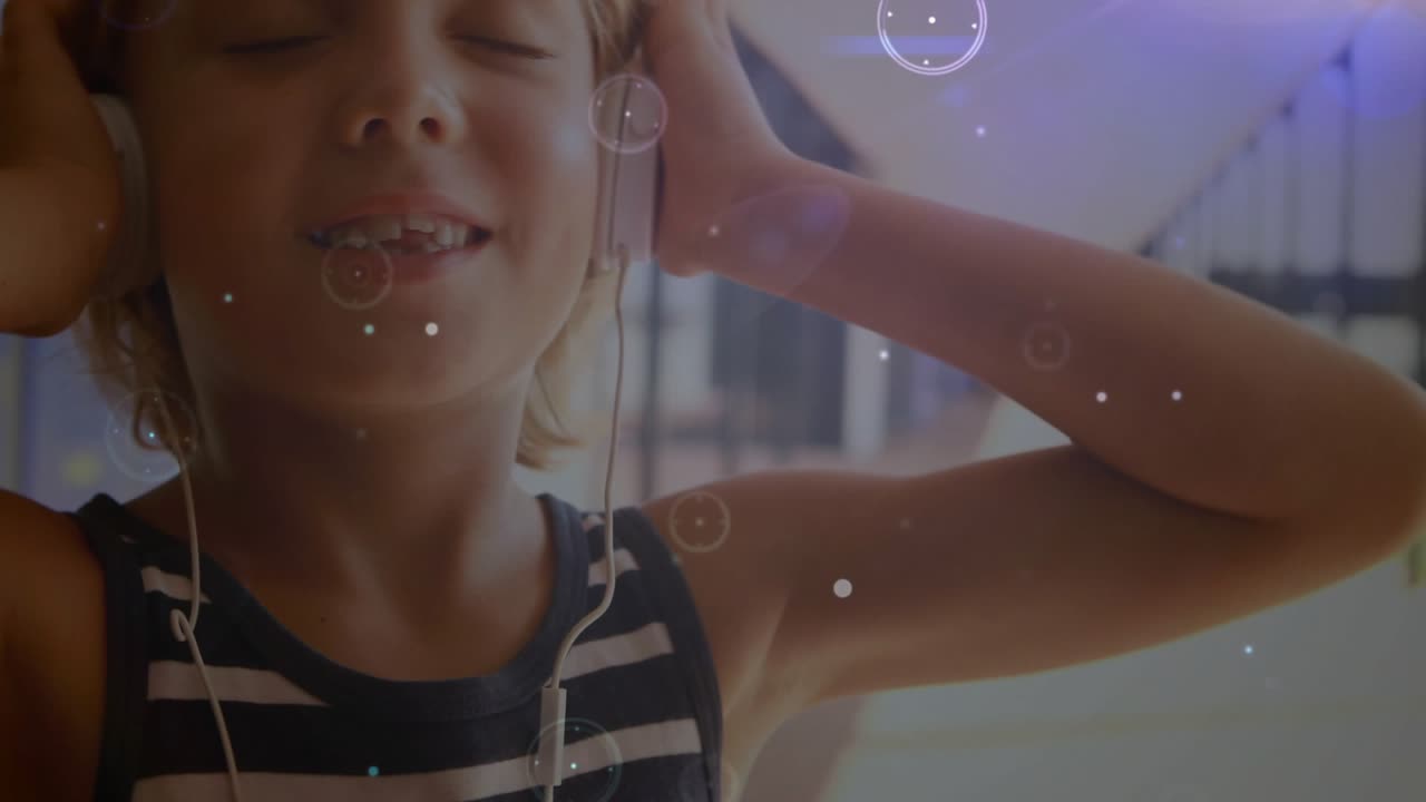 Boy placing headphones on ears on balcony, activating bubbles, neon beams for entertainment