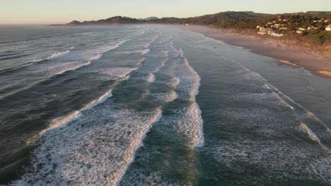 Peaceful-evening-aerial-of-waves-and-beach-at-Newport,-Oregon