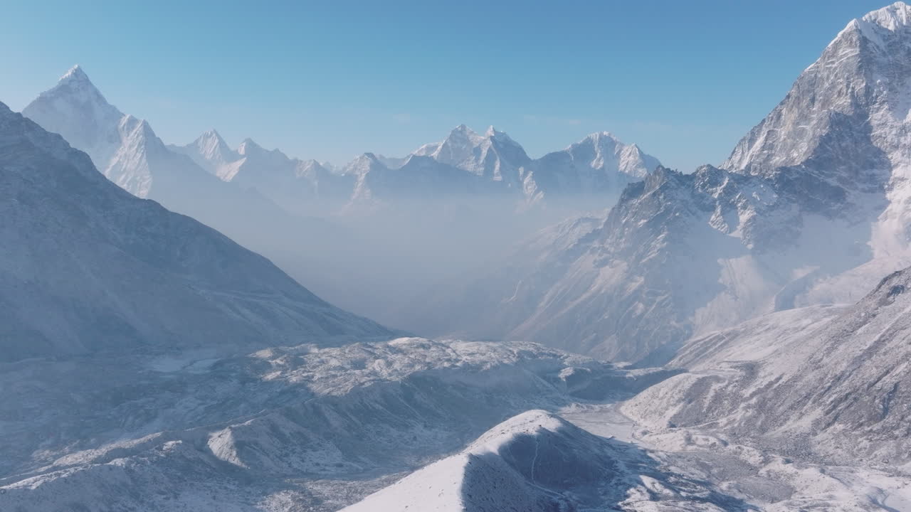 Aerial drone view over Everest Base Camp trek in Khumbu, Nepal. Morning light and majestic sunrays shine across snow-capped 8000m Himalayan mountains, revealing breathtaking high-altitude scenery