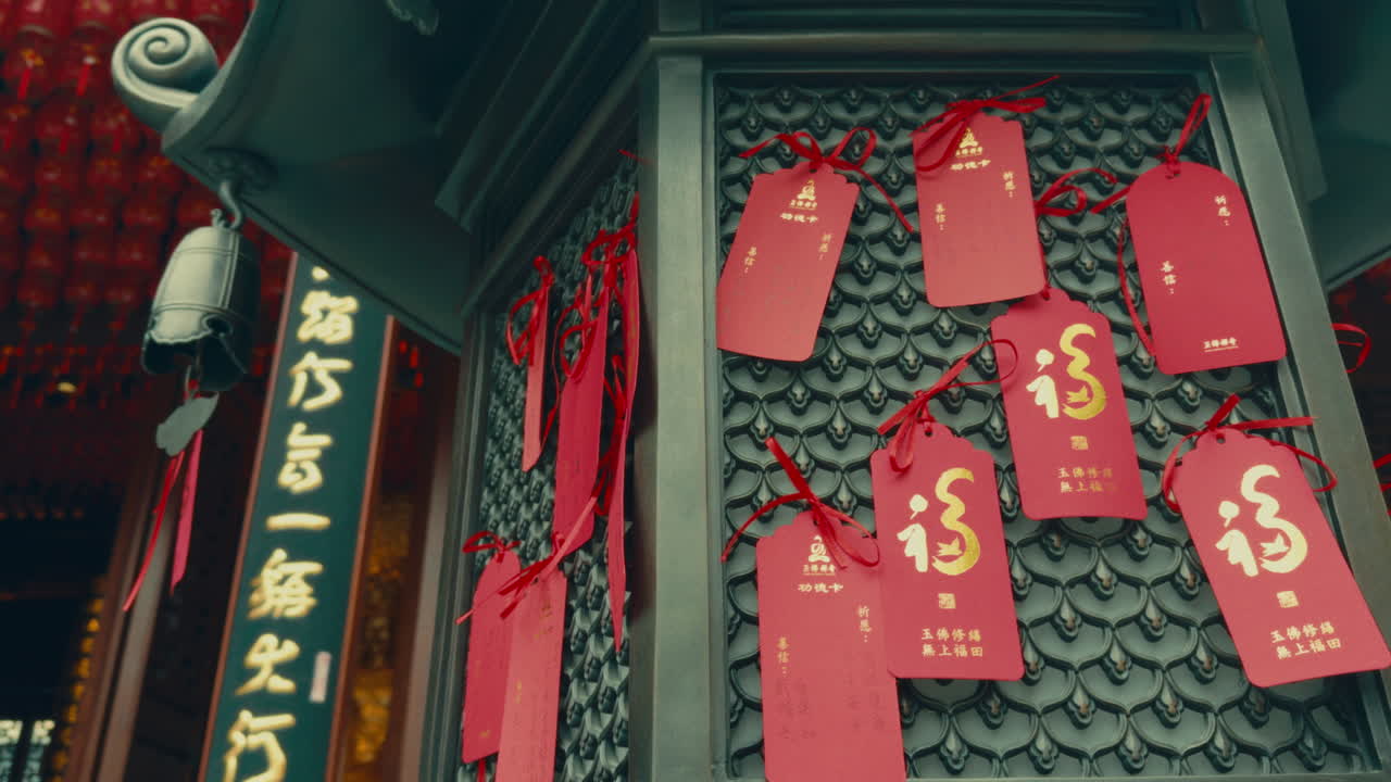Red tags with Chinese calligraphy hanging in a traditional temple in Wuzhen, China