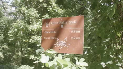 footage of a nature sign that says glenn falls trail with some graffiti on it in chattanooga, tn