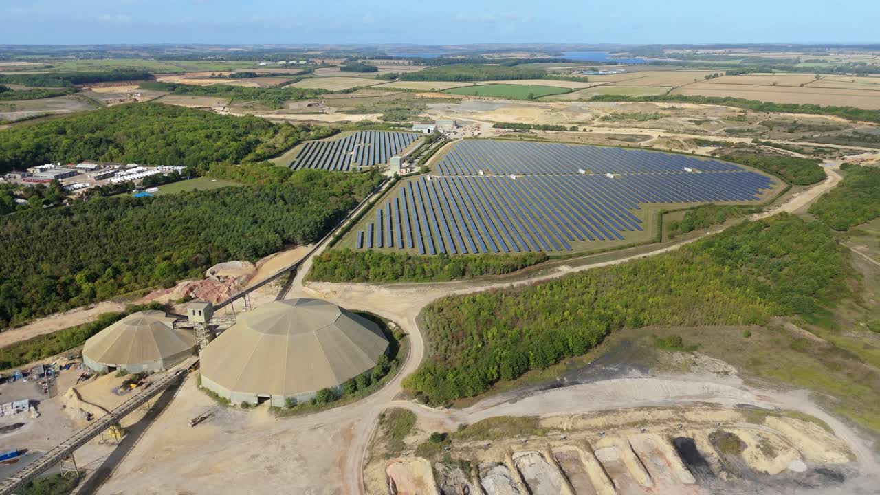 Cinematic drone orbit of solar power station in rural Leicester with photovoltaic cells