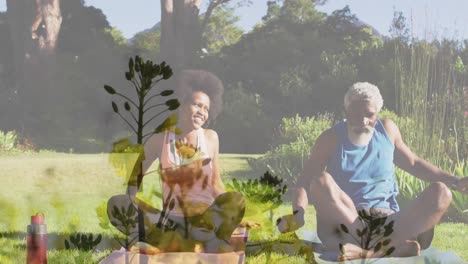 animation of plants over african american couple doing yoga, stretching, slow motion